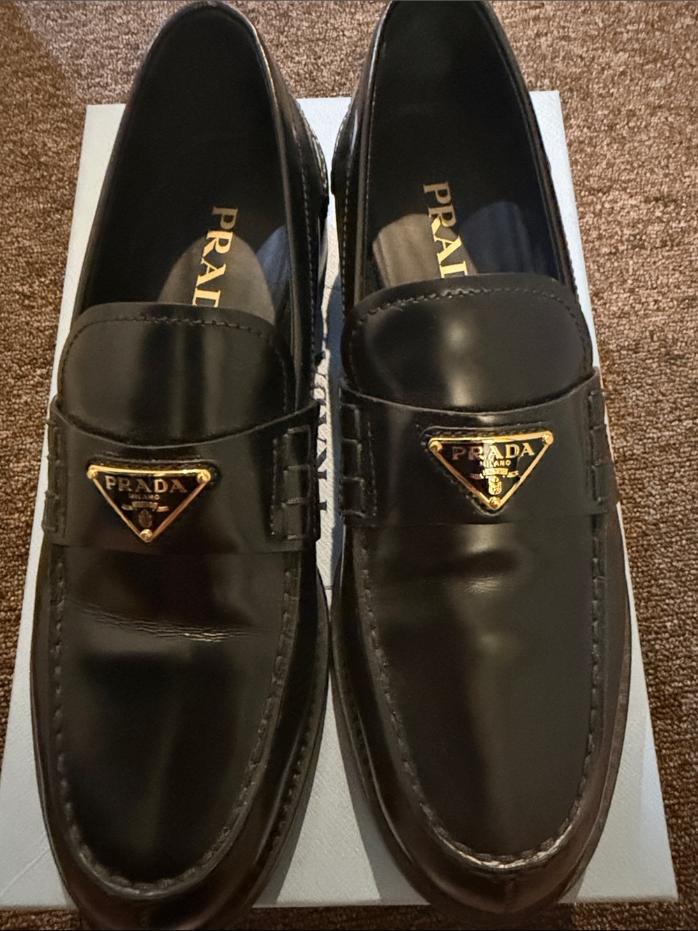 Prada Black Leather Slip-On Loafers with Gold Triangle Logo